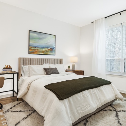 Sleep in style bedroom with a desk, chair and large window