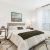 bedroom with a desk, chair and large window