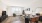 living area with a dining table and chairs and large windows