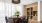 a room with a bookcase, round table and chairs