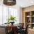 a room with a bookcase, round table and chairs