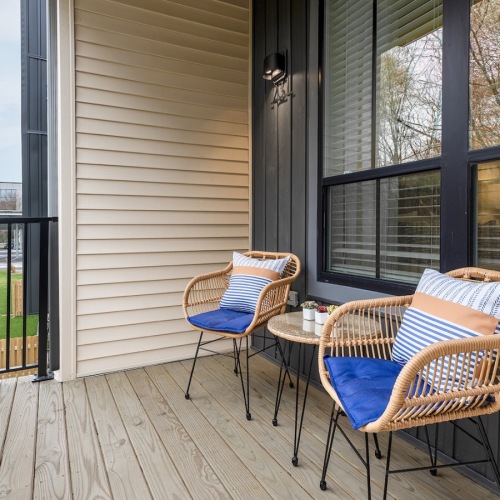 balcony with chairs and a table