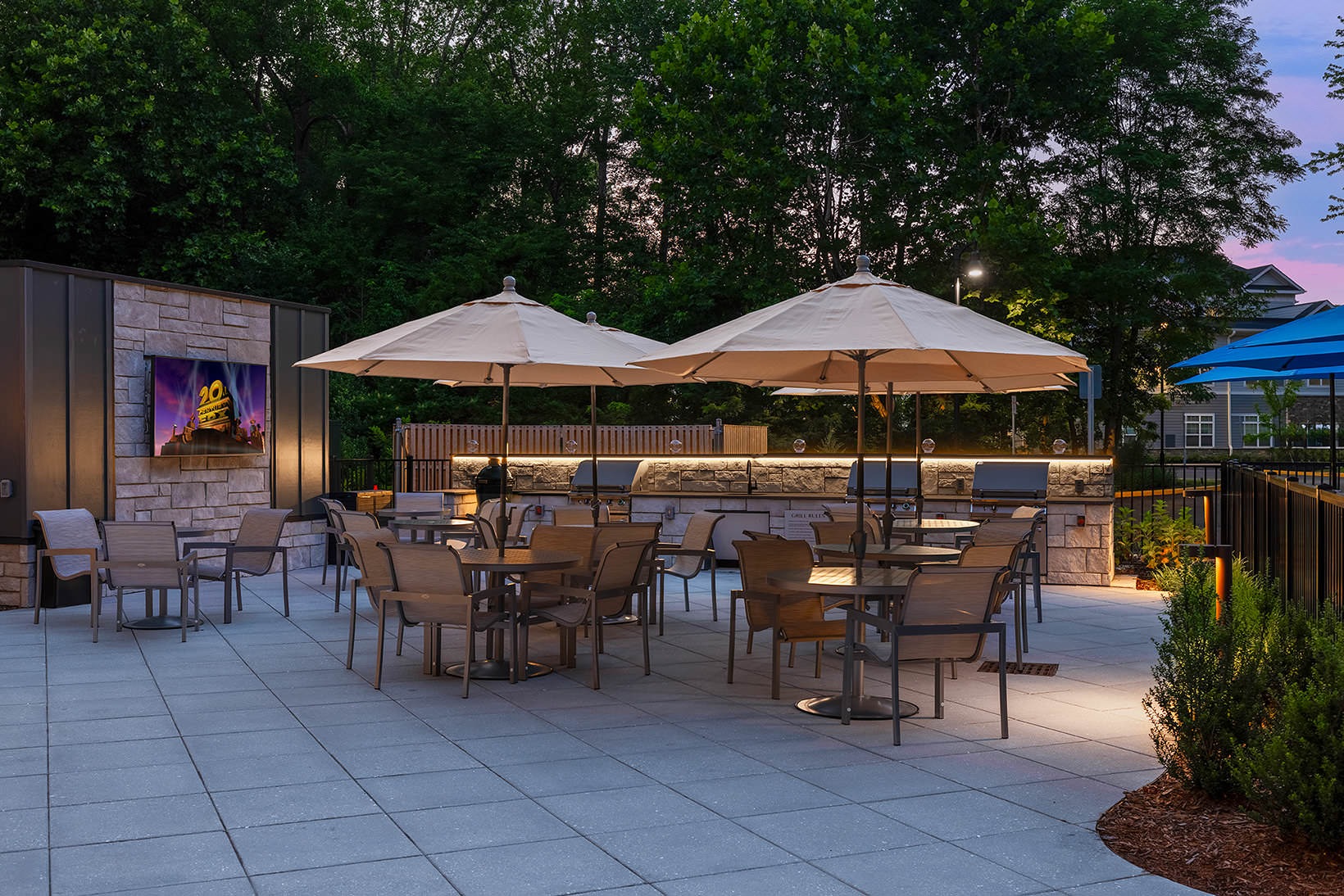 Thoughtful details to elevate your lifestyle outdoor movie wall with tables and chairs