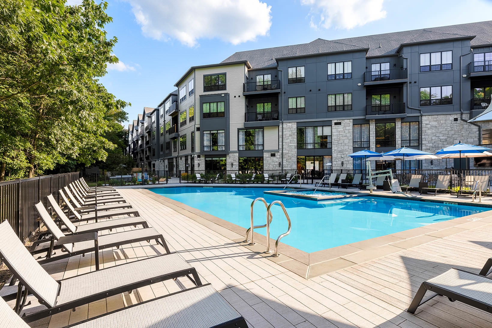 Relax and unwind poolside outdoor swimming pool surrounded by lounge chairs