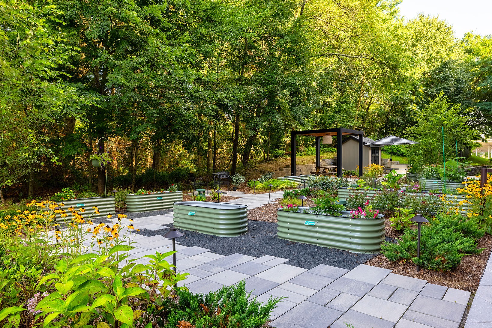 Enjoy our resident-only features Outdoor garden at Sylvan Woods Evesham apartments in Marlton, NJ, featuring flowers, trees, and a walking path.